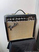 Front view of Fender Frontman 15G guitar amplifier showing speaker grille, logo, and control panel.