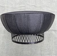 Top and side view of the large mid-century ottoman showing black faux-leather panel upholstery and metal lattice base.