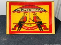 Front view of the glass dish showing vibrant retro decal of two parrots under umbrella with 'The Inseparables' text