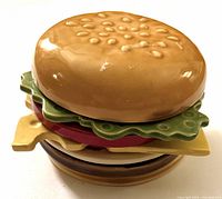 Stack of all seven ceramic coasters assembled to resemble a complete hamburger