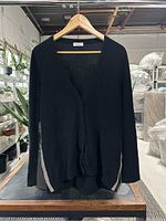 Front view of black cardigan on hanger