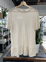 Front full view of cream sequin knit top on hanger