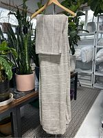 Full view of duvet cover and shams draped on hanger showing overall texture and color.