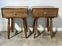 Two matching wood end tables front view showing drawers and legs