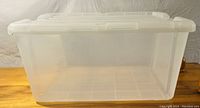 Clear view of the inside of the empty storage tote showing the translucency and size.
