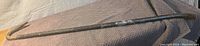 Photo of a metal crow bar placed on a blanket, showing the entire length and condition of the tool.
