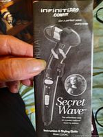 Instruction and styling guide for the Conair Infiniti Pro Secret Wave curling iron showing model BLD10P and product image.