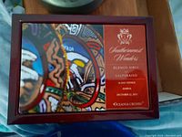 Rectangular wooden jewelry box with colorful travel-themed lid print, showing Southernmost Wonders cruise destinations and date