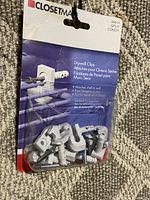 Front of package showing drywall clips and brand Closetmaid with product details in multiple languages
