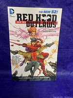 Front cover of Red Hood and the Outlaws Volume Redemption graphic novel showing main characters and title.