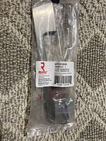 Richelieu Rocheleau metal pull handle BP7125128196 in original sealed plastic packaging.