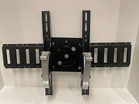Full view of the black metal TV wall mount bracket with two extendable arms and central mounting plate.