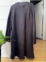 Back view of long grey knit cardigan showing length and texture.