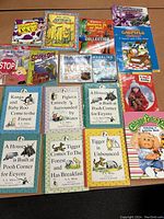 Photo of assorted children's books and novelty titles, various publishers, showing front covers laid out on a surface.