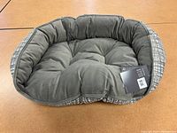 Top view of gray cushioned interior dog bed with raised sides and crosshatch patterned exterior fabric.