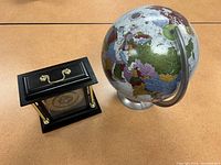 View of globe and mantel clock together showing general condition and size comparison.