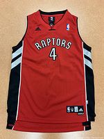 Front view of red Adidas Toronto Raptors basketball jersey with number 4 and Raptors text.