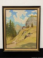 Full view of framed oil on board painting showing mountain landscape with house and trees