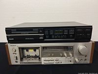 Front view of stacked Sony cassette deck and Philips CD player showing condition and wear.
