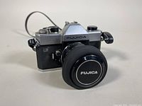 Front angle view showing Fujica ST801 body with lens cap on the Fujinon lens.