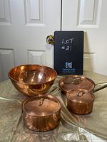 All four items assembled on table with lids attached