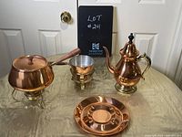 Full set showing fondue pot, teapot, butter warmer, and ashtray on table