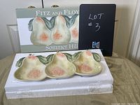 Sectioned pear-shaped ceramic serving plate displayed in front of the Fitz and Floyd Sommer Hill labeled box and protective packaging.