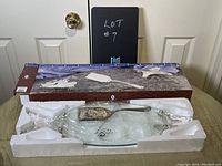 Glass fish shaped serving board with silver plated server together in packaging with box.