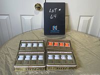 Four sets of four packages of golf balls on a fabric surface, showing original packaging and labels.