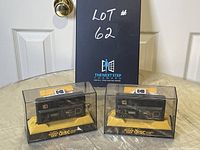 Two Kodak Disc 8000 cameras in original acrylic boxes on display stand with lot number sign behind.