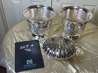 Overview of two ice buckets and clam shell server on display