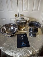Three silver plated items on table: urn, ice bucket with lid, and bowl; showing overall set appearance and condition.