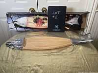 Photo of entire wooden fish board showing metal fish head and tail and original packaging.