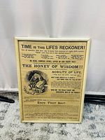 Front of the framed antique style news print art piece with detailed vintage text and illustration titled 'The Honey of Wisdom'.