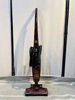 Front view of the upright Bissell vacuum cleaner showing cord and base components