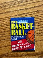 Front of the sealed 1991 Fleer Basketball card pack showing branding, basketball graphic, and pack details.