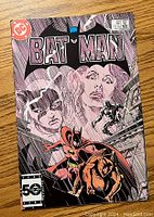 Front cover of Batman comic book issue 389 showing Batman, Catwoman, and other characters with DC logo and price on top left.