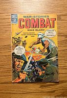 Front cover image of Combat #18 comic book showing action-packed war scene artwork with bright yellow and red colors and various text elements.