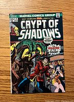 Front cover of Crypt of Shadows #2 comic book showing monster grabbing a man and woman with title and Marvel Comics branding