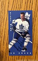 Front of the hockey card showing Eddie Shack in a Toronto Maple Leafs uniform with autograph across image.