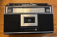 Front view of Lloyds cassette player and radio showing cassette slot, speakers, tuning dial, and controls