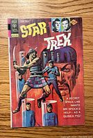 Front cover of Star Trek comic book issue #26 showing characters and the Gold Key logo.