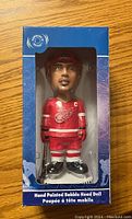 Front view of the sealed Steve Yzerman bobblehead in Detroit Red Wings uniform inside original packaging with blue border and clear display window.