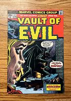 Front cover of the Vault of Evil #11 comic book showing artwork featuring a woman and a vampire bat figure with text bubbles and Marvel Comics Group branding.