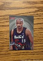 Front side of the Vince Carter rookie card showing him in Raptors uniform with 'Rookie' label and Fleer logo.