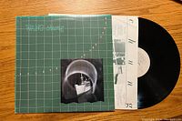 Front cover of Wang Chung vinyl record album showing green grid design and ship image.
