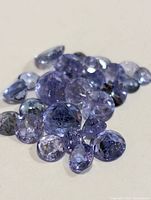 Group of multiple loose tanzanite gemstones displaying color and cut details