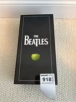 Photo of the black box with The Beatles logo and green apple design on front.