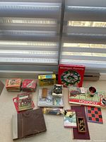 Wide shot of all items showing games, books, Mahjong, paintbrushes, and paint sets.