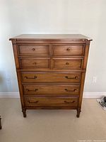Front view of highboy showing two small top drawers and three larger lower drawers with hardware